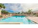 Community swimming pool featuring clear blue water, seating, and a landscaped area at 2782 Woodgate Ln # 18, Sarasota, FL 34231
