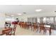 Spacious community recreation room with dining tables, sofas, and patio access at 2782 Woodgate Ln # 18, Sarasota, FL 34231