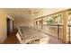 Outdoor covered recreation area with long dining table and patio furniture at 2782 Woodgate Ln # 18, Sarasota, FL 34231