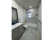 Stylish bathroom with gray vanity and tiled shower at 3813 42Nd W St # 37, Bradenton, FL 34205