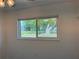 Bedroom featuring a view of a well-manicured lawn through a large window at 3813 42Nd W St # 37, Bradenton, FL 34205