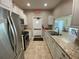 Functional kitchen featuring white cabinets, stainless steel appliances, and granite countertops at 3813 42Nd W St # 37, Bradenton, FL 34205