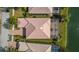 Aerial view of a home with a tile roof, screened-in lanai, and well-manicured landscaping at 5521 Bilbao Pl, Sarasota, FL 34238