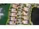 Aerial view of rooftops and community pools nestled between two lakes at 5521 Bilbao Pl, Sarasota, FL 34238