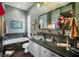 Detailed bathroom featuring mosaic-tiled accents, a glass bowl sink, and decorative wall art for a unique touch at 5521 Bilbao Pl, Sarasota, FL 34238