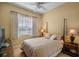 Cozy bedroom featuring a comfortable bed, soft lighting, and neutral decor at 5521 Bilbao Pl, Sarasota, FL 34238