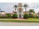 Beautiful community center featuring a clock tower, well-manicured landscaping, and elegant architecture at 5521 Bilbao Pl, Sarasota, FL 34238