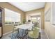 Bright dining room featuring views of the living area and an attractive modern light fixture at 5521 Bilbao Pl, Sarasota, FL 34238