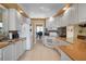 Well-lit kitchen featuring white cabinetry, modern appliances, tiled floors, and an inviting breakfast bar at 5521 Bilbao Pl, Sarasota, FL 34238