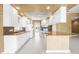 Well-lit kitchen featuring white cabinetry, stainless steel appliances, and a breakfast bar at 5521 Bilbao Pl, Sarasota, FL 34238