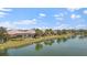 Scenic view of waterfront homes with screened lanais reflected on a peaceful lake at 5521 Bilbao Pl, Sarasota, FL 34238