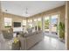 Inviting living room with tile floors, neutral furniture, and abundant natural light from large windows at 5521 Bilbao Pl, Sarasota, FL 34238