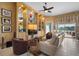Cozy living room with custom built-ins, display shelving, and serene water views from the adjacent lanai at 5521 Bilbao Pl, Sarasota, FL 34238
