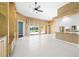 Spacious living room with beautiful tile floors and large sliding glass doors leading to the lanai at 5521 Bilbao Pl, Sarasota, FL 34238