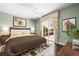 Well-lit bedroom featuring a ceiling fan, a sliding glass door to the patio, and neutral decor at 5521 Bilbao Pl, Sarasota, FL 34238