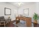 Bright home office with hardwood floors, modern desk, a comfortable chair, and a large window for natural light at 5521 Bilbao Pl, Sarasota, FL 34238