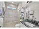Bathroom features a glass shower, black granite countertop, and modern fixtures at 8612 Sundance Loop, Sarasota, FL 34238