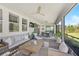 Covered lanai with ceiling fans, comfortable seating, and views of the outdoors at 8612 Sundance Loop, Sarasota, FL 34238