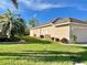 Well-maintained single-story home showcasing a lush green lawn and manicured landscaping at 958 Chickadee Dr, Venice, FL 34285