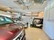 Spacious garage with ample storage, featuring a golf cart and multiple vehicles at 958 Chickadee Dr, Venice, FL 34285