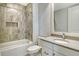 Bathroom featuring a shower with tub and neutral toned tile accent wall at 10510 Boardwalk Loop # 602, Bradenton, FL 34202