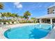 Beautiful pool area featuring palm trees, comfortable lounge chairs, and a covered outdoor seating area at 10510 Boardwalk Loop # 602, Bradenton, FL 34202