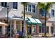 Shops in the town center with green awnings and palm trees at 10510 Boardwalk Loop # 602, Bradenton, FL 34202