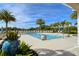 Stunning pool area with palm trees and stylish landscaping offers a luxurious and relaxing atmosphere at 10510 Boardwalk Loop # 602, Bradenton, FL 34202