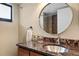 Bathroom vanity features granite counter, mosaic backsplash, and brushed nickel faucet at 11 Sunset Dr # 406, Sarasota, FL 34236