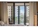 Bedroom featuring balcony with city views, and natural light through the sliding glass doors at 11 Sunset Dr # 406, Sarasota, FL 34236