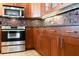 Modern kitchen featuring stainless steel appliances, wooden cabinets, and tiled backsplash at 11 Sunset Dr # 406, Sarasota, FL 34236