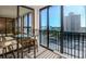 Enjoy the beautiful water view from the lanai area with a glass table and outside furnishing at 11 Sunset Dr # 406, Sarasota, FL 34236