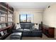 Living room with waterfront views, and a dark leather sofa at 11 Sunset Dr # 406, Sarasota, FL 34236