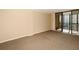 Neutral living room with carpet and balcony access showcasing natural light at 11 Sunset Dr # 406, Sarasota, FL 34236