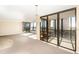 Spacious living area with large windows, carpeted floors, and access to a balcony with views of the city at 11 Sunset Dr # 406, Sarasota, FL 34236