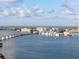 Enjoy this waterfront view of the city featuring a picturesque bridge, luxury condominiums, and clear, blue waters at 11 Sunset Dr # 406, Sarasota, FL 34236