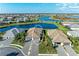 An aerial view of a neighborhood featuring waterways and houses with tile roofs and paver driveways on well manicured lots at 15917 Clear Skies Pl, Lakewood Ranch, FL 34211