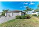 A single story house with a 2-car garage, tile roof, paver driveway and tropical landscaping at 15917 Clear Skies Pl, Lakewood Ranch, FL 34211