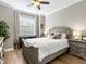 Cozy bedroom featuring a wood bed frame, bedside tables with lamps, and a window for natural light at 17459 Hickok Belt Loop, Bradenton, FL 34211