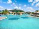 Enjoy the community pool with waterfalls, palm trees, and shaded seating areas at 17459 Hickok Belt Loop, Bradenton, FL 34211