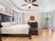 Light and bright main bedroom with tray ceiling, wood floors, and natural light from the outdoor view at 17459 Hickok Belt Loop, Bradenton, FL 34211