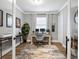 Home office space with crown molding, a neutral rug, a work desk, and natural light from the window at 17459 Hickok Belt Loop, Bradenton, FL 34211