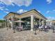 Enjoy outdoor dining in a covered pavilion with tables, chairs, and a nearby bar at 17459 Hickok Belt Loop, Bradenton, FL 34211