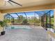 Screened-in pool area with a spa and paved deck perfect for outdoor entertaining and relaxation at 17459 Hickok Belt Loop, Bradenton, FL 34211