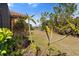 Lush backyard featuring tropical foliage and view of the pond at 26720 Weiskopf Dr, Englewood, FL 34223