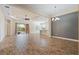 Open living space with tile floors, a tray ceiling, and sliding glass doors to a screened lanai at 26720 Weiskopf Dr, Englewood, FL 34223