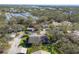 A high-angle view reveals the home's location, neighboring houses, and the lush, wooded surroundings at 3443 Tallywood Cir # 7061, Sarasota, FL 34237