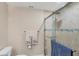 Tiled walk-in shower with glass door, towel rack, and commode at 3443 Tallywood Cir # 7061, Sarasota, FL 34237