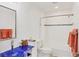 Bathroom featuring an eye-catching blue glass vessel sink, a tiled shower/tub combination, and stylish fixtures at 3443 Tallywood Cir # 7061, Sarasota, FL 34237