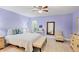 A calming bedroom featuring tile floors, a ceiling fan, and a cozy sitting area at 3443 Tallywood Cir # 7061, Sarasota, FL 34237